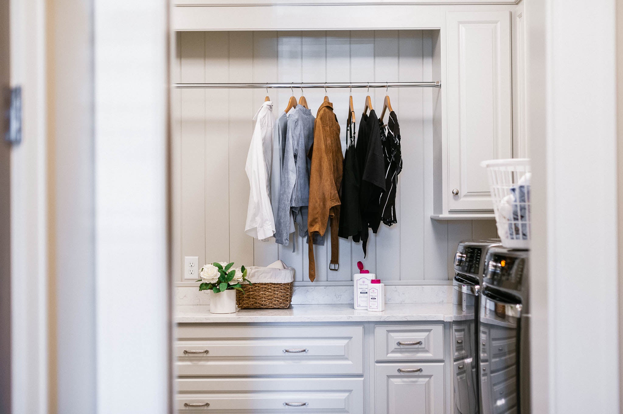 hanging clothes in a closet with forever new products