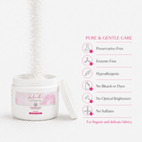 A white plastic jar of Superfine New Delicate Care Cream with its lid off, showing white powder pouring out. The label has pink accents.