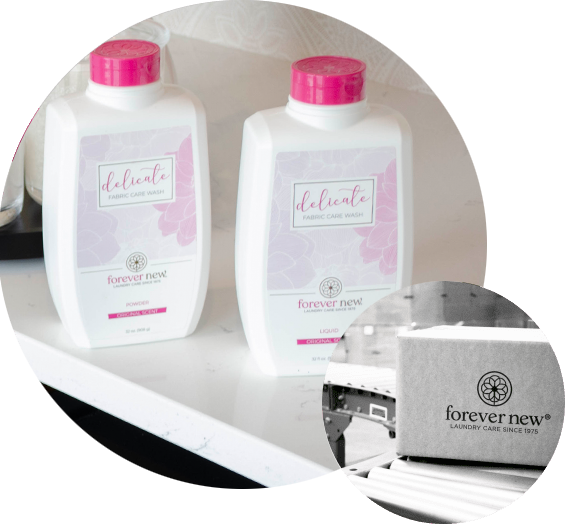 Two bottles of 'delicate' laundry detergent with pink caps on a white background, featuring the brand 'forever new'.